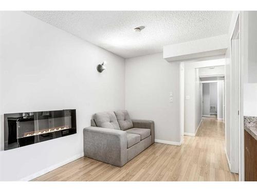 139 Saddlecrest Close Ne, Calgary, AB - Indoor Photo Showing Living Room With Fireplace