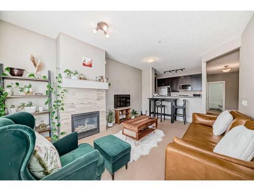 202-518 33 Street Nw, Calgary, AB - Indoor Photo Showing Living Room With Fireplace