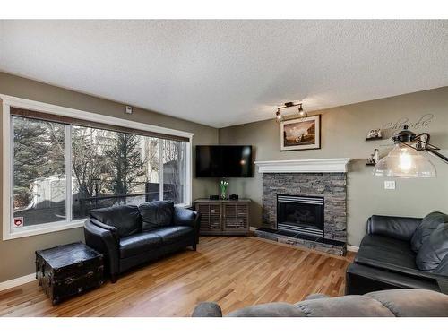 48 Arbour Crest Court Nw, Calgary, AB - Indoor Photo Showing Living Room With Fireplace