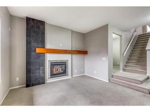 20 Copperpond Heights Se, Calgary, AB - Indoor Photo Showing Living Room With Fireplace