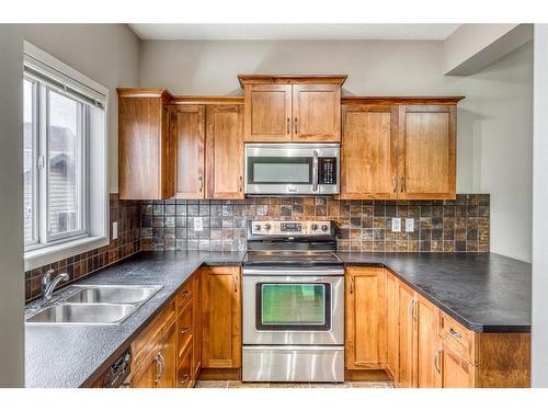 20 Copperpond Heights Se, Calgary, AB - Indoor Photo Showing Kitchen With Double Sink