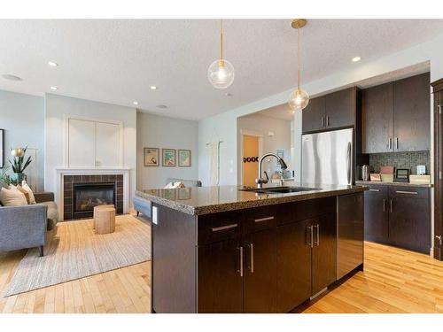 98 Discovery Ridge Gardens Sw, Calgary, AB - Indoor Photo Showing Kitchen With Fireplace With Upgraded Kitchen