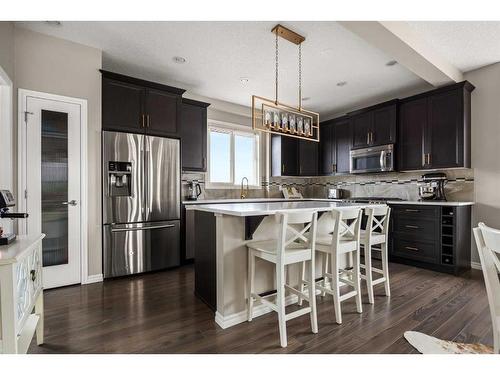 4 Heritage Boulevard, Cochrane, AB - Indoor Photo Showing Kitchen With Stainless Steel Kitchen With Upgraded Kitchen