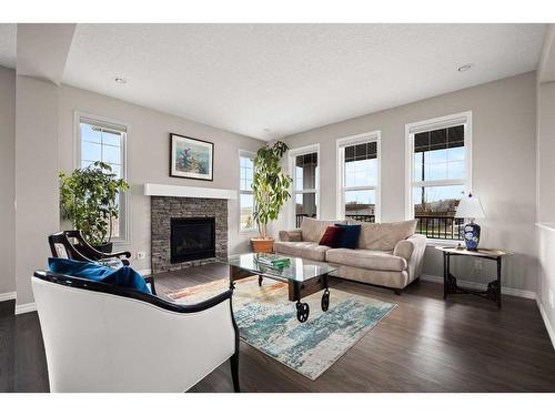 4 Heritage Boulevard, Cochrane, AB - Indoor Photo Showing Living Room With Fireplace