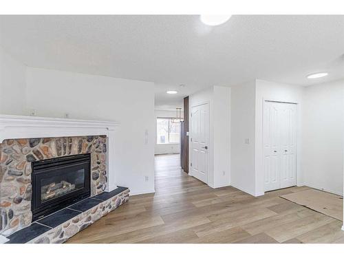 133 Taravista Crescent Ne, Calgary, AB - Indoor Photo Showing Living Room With Fireplace