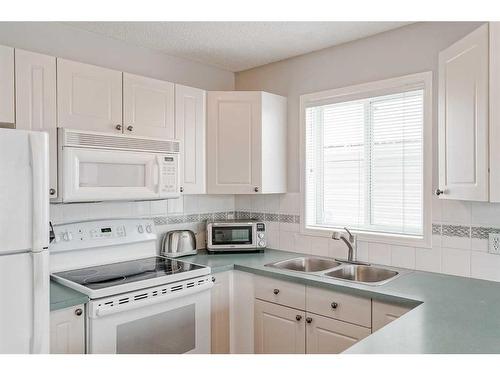 64 Chaparral Ridge Circle Se, Calgary, AB - Indoor Photo Showing Kitchen With Double Sink