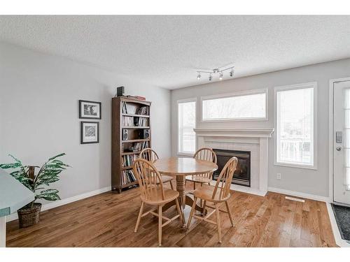 64 Chaparral Ridge Circle Se, Calgary, AB - Indoor Photo Showing Dining Room With Fireplace