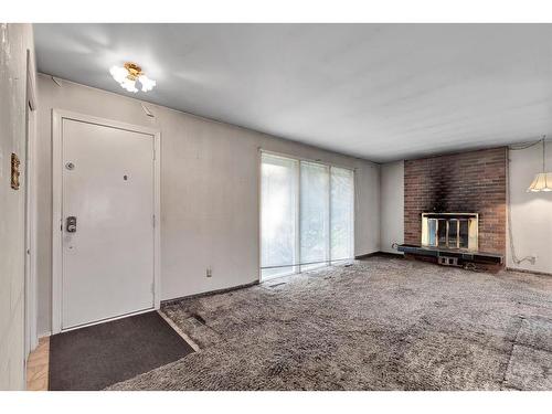 90 Lynnwood Drive Se, Calgary, AB - Indoor Photo Showing Other Room With Fireplace