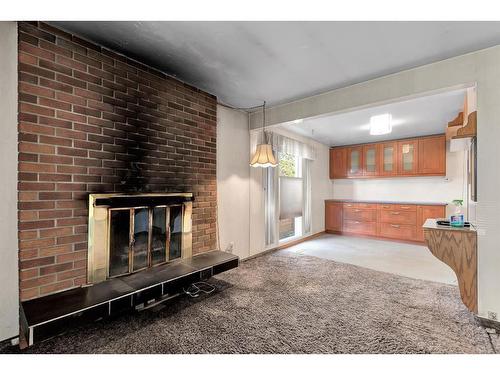 90 Lynnwood Drive Se, Calgary, AB - Indoor Photo Showing Other Room With Fireplace