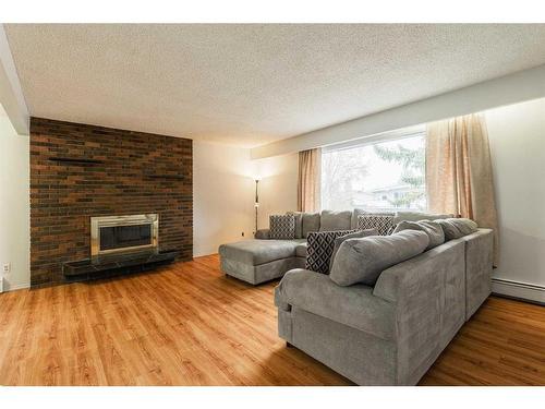 7607 35 Avenue Nw, Calgary, AB - Indoor Photo Showing Living Room With Fireplace