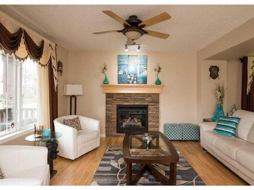 126 Silverado Plains Circle Sw, Calgary, AB - Indoor Photo Showing Living Room With Fireplace