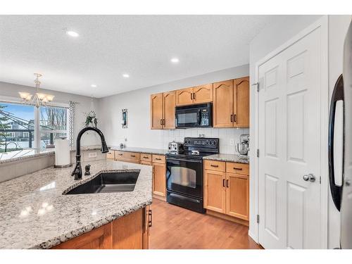 54 Chapalina Green Se, Calgary, AB - Indoor Photo Showing Kitchen With Double Sink