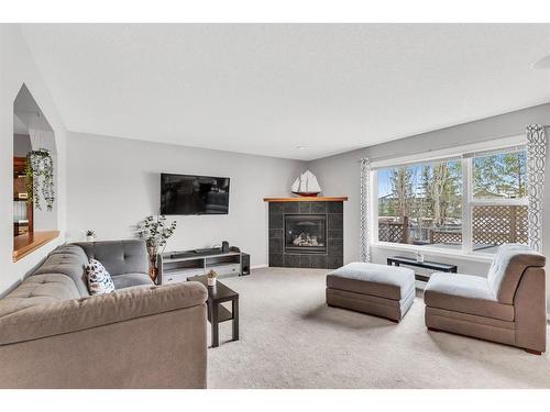 54 Chapalina Green Se, Calgary, AB - Indoor Photo Showing Living Room With Fireplace