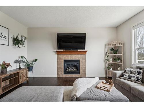 129 Heritage Hill, Cochrane, AB - Indoor Photo Showing Living Room With Fireplace