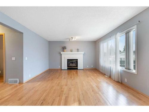 7269 California Boulevard Ne, Calgary, AB - Indoor Photo Showing Living Room With Fireplace