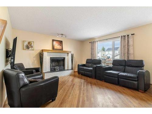338 Mt Cornwall Circle Se, Calgary, AB - Indoor Photo Showing Living Room With Fireplace