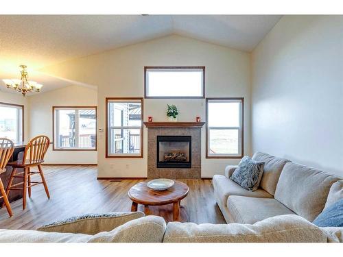 203 Bishop Mews Nw, Langdon, AB - Indoor Photo Showing Living Room With Fireplace
