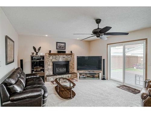 68 Woodford Close Sw, Calgary, AB - Indoor Photo Showing Living Room With Fireplace