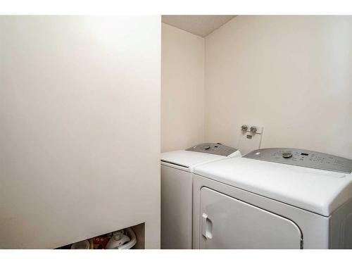 68 Woodford Close Sw, Calgary, AB - Indoor Photo Showing Laundry Room