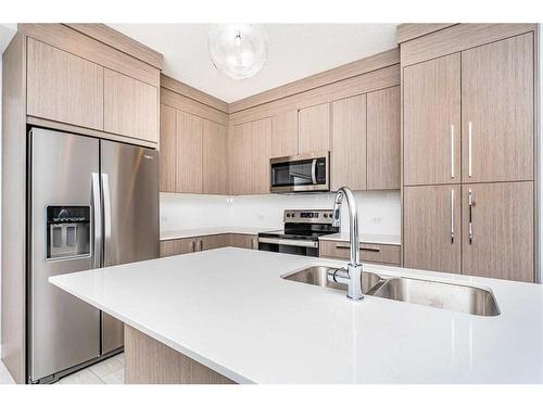 1218-681 Savanna Boulevard Ne, Calgary, AB - Indoor Photo Showing Kitchen With Double Sink With Upgraded Kitchen