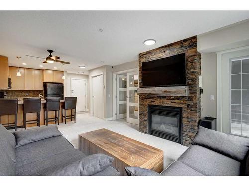 236-35 Richard Court Sw, Calgary, AB - Indoor Photo Showing Living Room With Fireplace