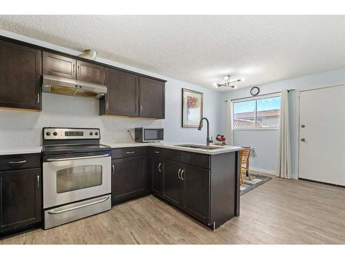 306 Falwood Way Ne, Calgary, AB - Indoor Photo Showing Kitchen With Double Sink