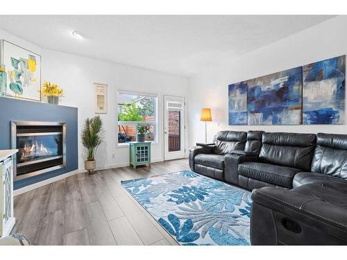 220 Chapala Drive Se, Calgary, AB - Indoor Photo Showing Living Room With Fireplace