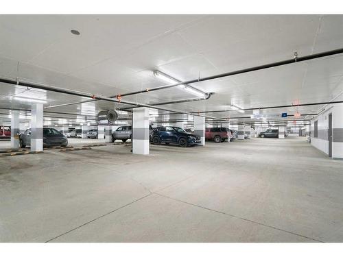 207-138 Waterfront Court Sw, Calgary, AB - Indoor Photo Showing Garage