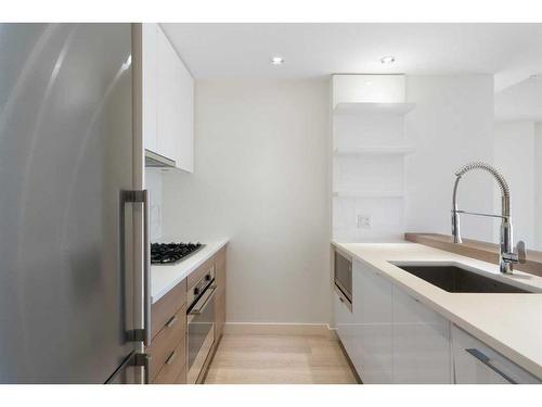 207-138 Waterfront Court Sw, Calgary, AB - Indoor Photo Showing Kitchen With Upgraded Kitchen