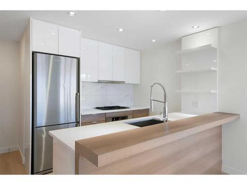 207-138 Waterfront Court Sw, Calgary, AB - Indoor Photo Showing Kitchen With Stainless Steel Kitchen With Upgraded Kitchen