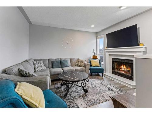 144 Whitlow Place Ne, Calgary, AB - Indoor Photo Showing Living Room With Fireplace