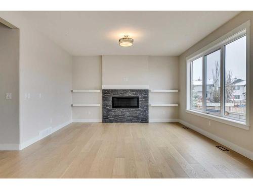 1512 Coopers Point Sw, Airdrie, AB - Indoor Photo Showing Living Room With Fireplace