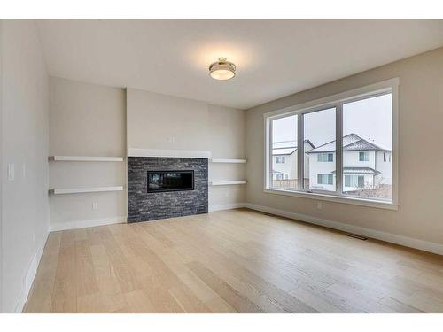 1512 Coopers Point Sw, Airdrie, AB - Indoor Photo Showing Living Room With Fireplace
