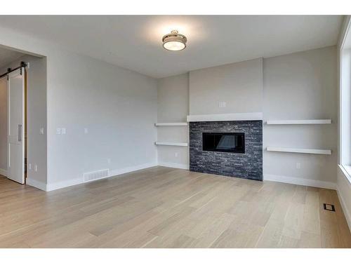 1512 Coopers Point Sw, Airdrie, AB - Indoor Photo Showing Living Room With Fireplace