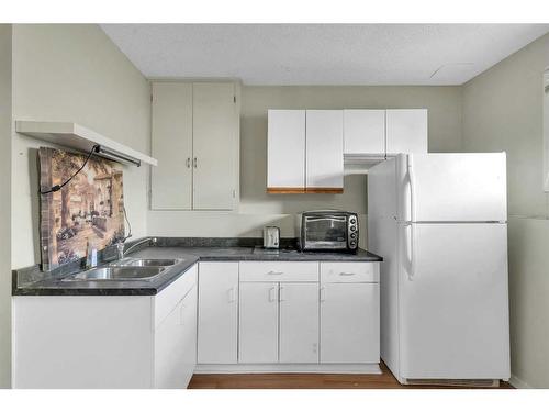 36 Whitehaven Road Ne, Calgary, AB - Indoor Photo Showing Kitchen With Double Sink