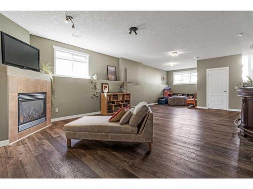 256 Sunset Heights, Crossfield, AB - Indoor Photo Showing Other Room With Fireplace