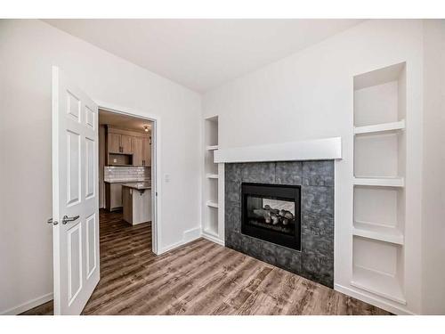563 Osborne Drive, Airdrie, AB - Indoor Photo Showing Living Room With Fireplace