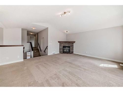161 Cranwell Bay Se, Calgary, AB - Indoor Photo Showing Living Room With Fireplace