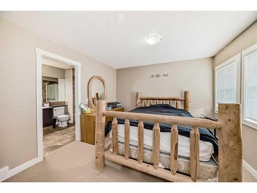 81-28 Heritage Drive, Cochrane, AB - Indoor Photo Showing Bedroom