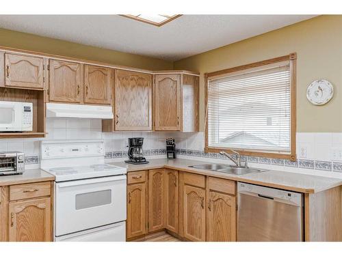 105 Arbour Ridge Circle Nw, Calgary, AB - Indoor Photo Showing Kitchen With Double Sink