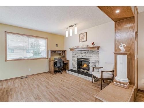 105 Arbour Ridge Circle Nw, Calgary, AB - Indoor Photo Showing Living Room With Fireplace