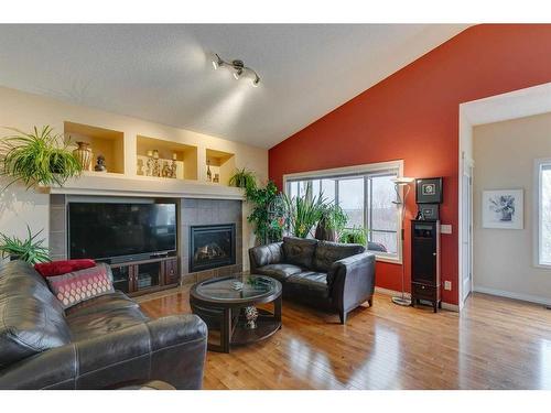221 Sunset Heights, Cochrane, AB - Indoor Photo Showing Living Room With Fireplace