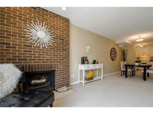 202-611 67 Avenue Sw, Calgary, AB - Indoor Photo Showing Living Room With Fireplace