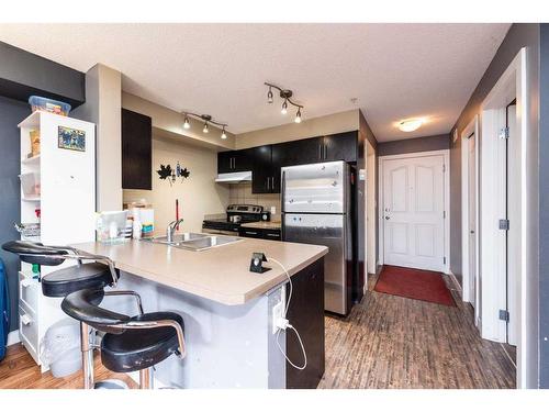 305-7130 80 Avenue Ne, Calgary, AB - Indoor Photo Showing Kitchen With Double Sink