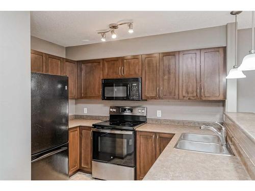 138 Eversyde Common Sw, Calgary, AB - Indoor Photo Showing Kitchen With Double Sink