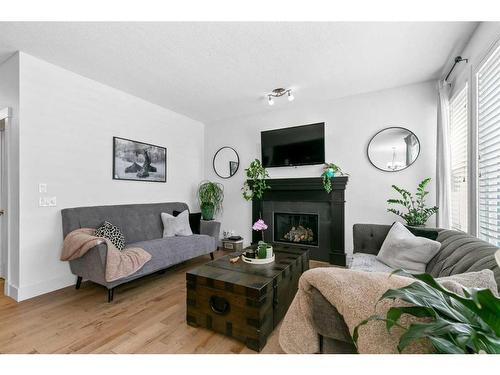 234 Mountainview Drive Nw, Okotoks, AB - Indoor Photo Showing Living Room With Fireplace