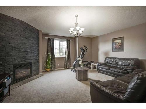 158 Tuscarora Close Nw, Calgary, AB - Indoor Photo Showing Living Room With Fireplace
