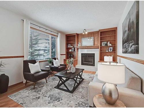 128 Edgebank Circle Nw, Calgary, AB - Indoor Photo Showing Living Room With Fireplace