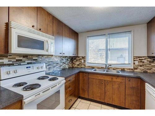 112 Pennsburg Way Se, Calgary, AB - Indoor Photo Showing Kitchen With Double Sink