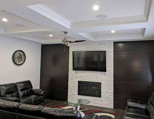 305 Kinniburgh Cove, Chestermere, AB - Indoor Photo Showing Living Room With Fireplace